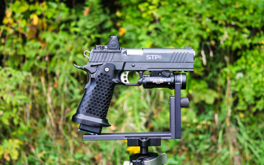 STP S.W.A.T. 5.0 HEX Optics 9mm 2011 pistol resting on a shooting rest