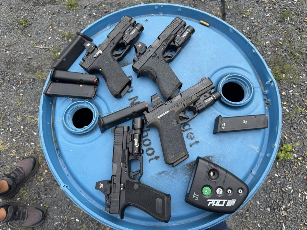 A Glock 47, two Glock 17 Gen 6 pistols, and a Ruger RXM laid out for side-by-side range testing
