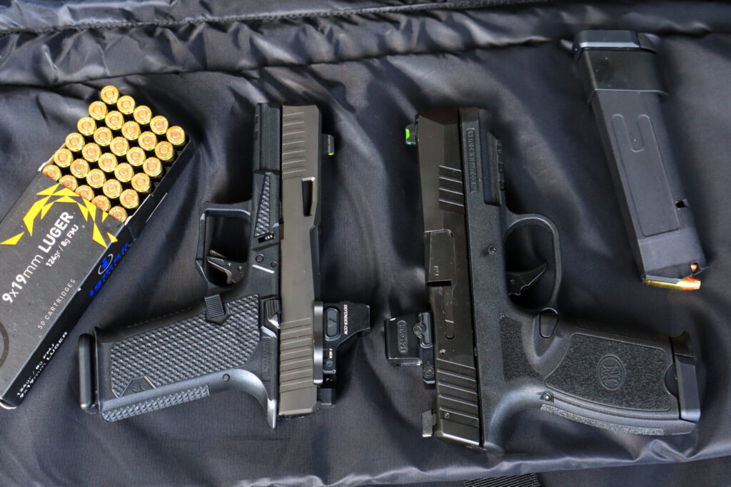 The FN 309 MRD pistol beside a Rainier Dusk 19 Glock-pattern pistol and a box of 9mm ammunition