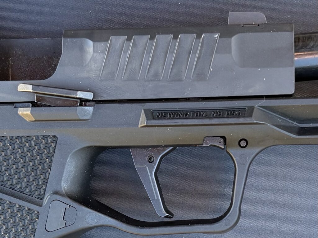 There is a trigger safety here, but the blade is actually in the shoe, rather than protruding from the face of the trigger shoe. Pull on the side of the trigger, and it won't fire a round.