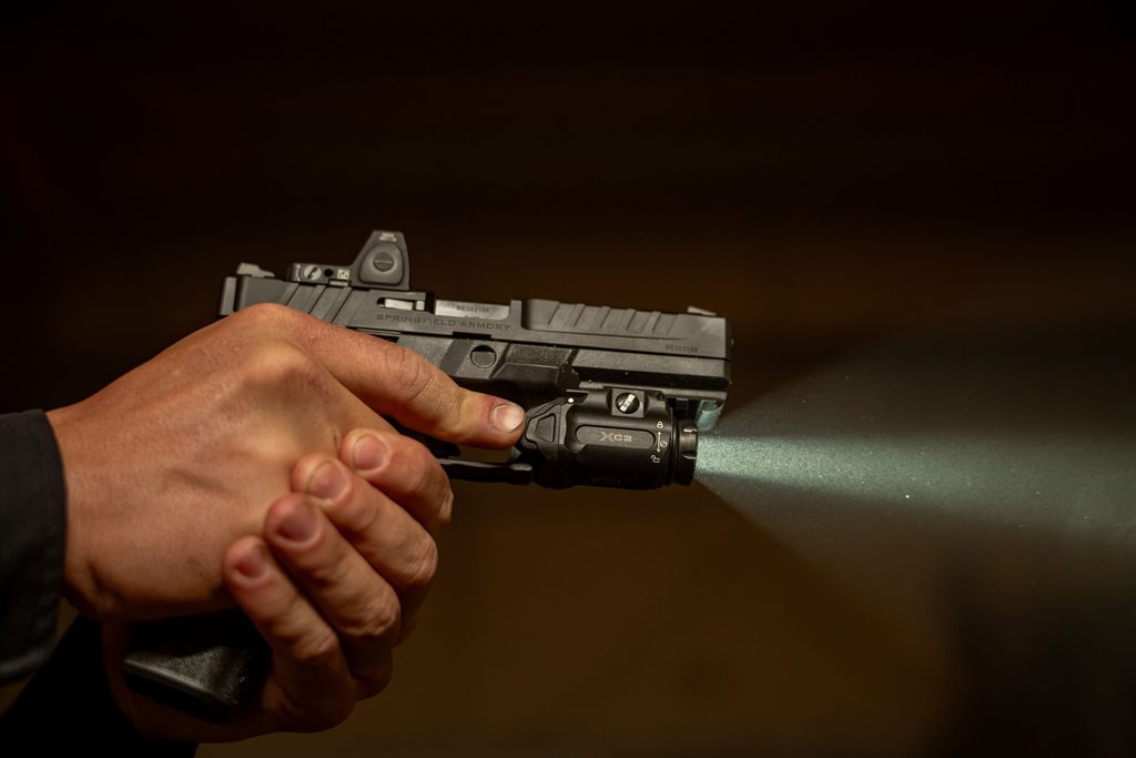 The SureFire XC3-B weaponlight mounted on a compact handgun, showing its compact, low-profile body.