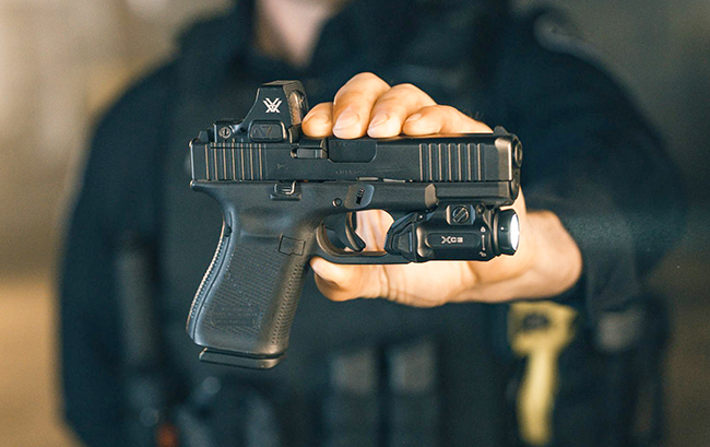 xc3B weapon light rail-mounted with vortex optic on top.