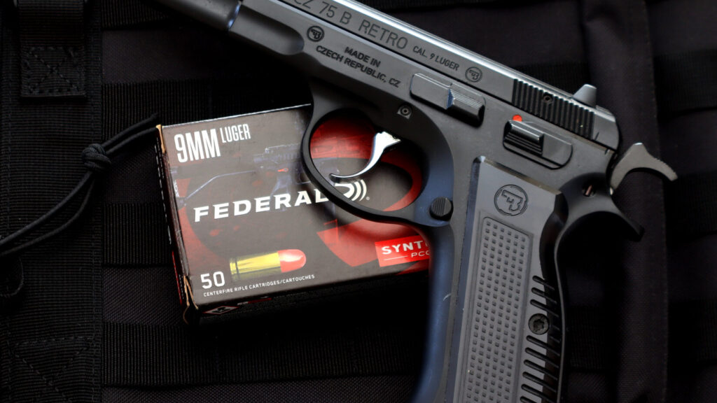 CZ 75 9mm Luger chambered pistol with a box of 9mm Luger ammunition
