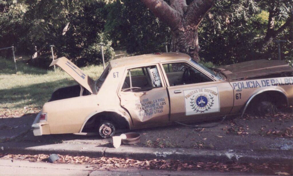 A shot-up tan Balboa Police vehicle during Operation Just Cause in Panama.