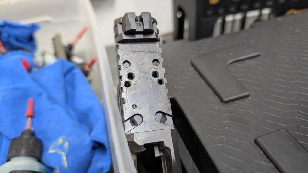 Top-down close-up of the CZ DUTY slide's direct-mount optic cut, showing multiple screw and pin holes