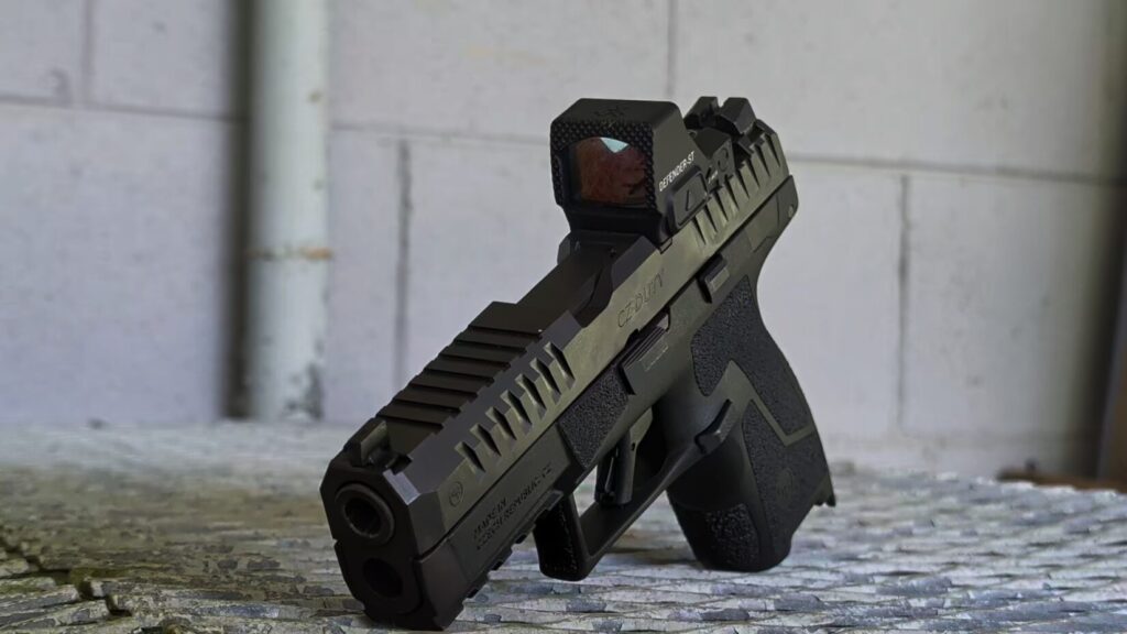 CZ DUTY pistol with a Vortex Defender-ST red dot standing upright, viewed from the front left